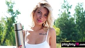 Petite blondie Eva Tali strips naked for beach sunbath