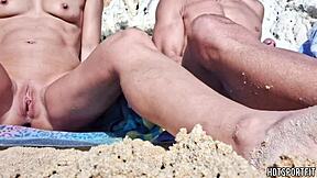 Hot athletic couple flashes mutual masturbation handjob on public beach