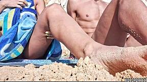 Hot athletic couple flashes mutual masturbation handjob on public beach