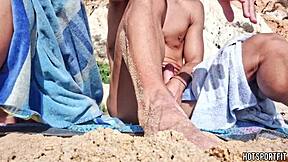 Hot athletic couple flashes mutual masturbation handjob on public beach