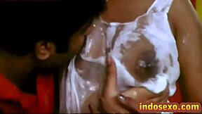 young guy licks honey off indian older woman's big tits