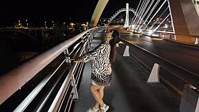 😏 luscious milf struts bra-less panty-free over the bridge, flashing those huge tits! 🔥