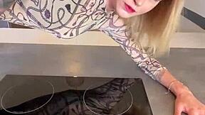 sophie van loo heats kitchen counter in gray leggings high heels