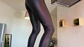 sophie van loo heats kitchen counter in gray leggings high heels