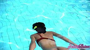 Petite Asian swims plugged then plays with gaping ass outdoors