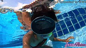 Petite Asian swims plugged then plays with gaping ass outdoors