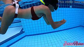 Petite Asian swims plugged then plays with gaping ass outdoors