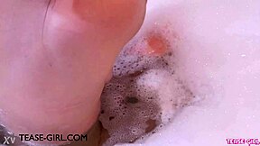 gorgeous brunette relaxes in a steamy bath during casting photoshoot