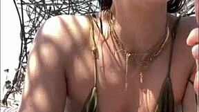 that nympho redhead beach babe fingers her sandy wet pussy non-stop