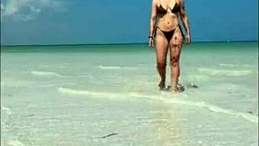 that nympho redhead beach babe fingers her sandy wet pussy non-stop