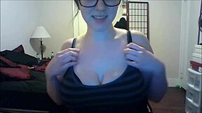 cute glasses girl squeezes and bounces her huge natural boobs