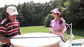 Golf bitch drops knees sucking two hard cocks deep!