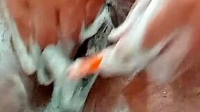 Young brunette shaves hairy pussy closeup in bathroom