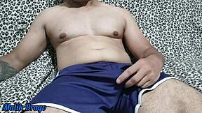 young guy in shorts jerks huge cock to explosion