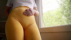naughty stepsis in tight yoga pants teases her fat cameltoe pussy lips relentlessly while stretching and bending over provocatively in the living room