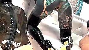 backstage latex femdom shoot with petite goth licking pierced nipples and pussy