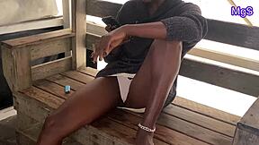 Sexy African milf flashes naughty pussy and tits at public beach
