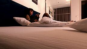 hot brunette tattooed girl on the bed changes her panties by taking underwear under skirt