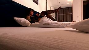 hot brunette tattooed girl on the bed changes her panties by taking underwear under skirt