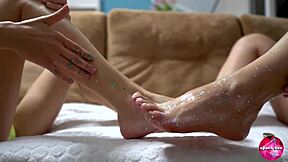 Two CUTIES with SHINY LEGS PLAY with HUGE RUBBER COCK in FOOTJOB fun.