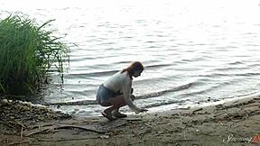 teen redhead mia reaches intense orgasm by the lake in solo play