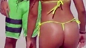 young girl struts a tiny bikini on the beach while boyfriend’s relatives watch.