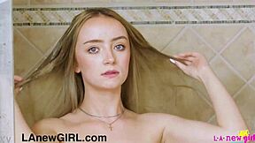 Cute petite blonde teen enjoys a relaxing shower after photoshoot on sofa.