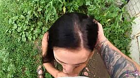 the horny student with long hair and brown eyes gives a sloppy blowjob behind the garages