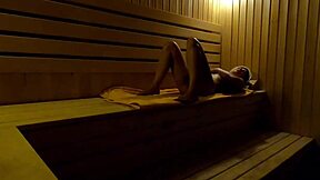 Caught on hidden cam, girl fingers herself in sauna at night