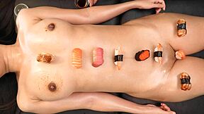 japanese sushi girl poses with food and shaved ass