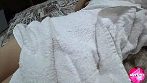 Cute girl plays with toy while parents watch TV in next room