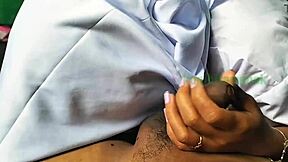 Asian couple practicing handjob techniques outdoors in a homemade video.