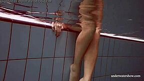 Lola shows her big natural tits while swimming underwater.