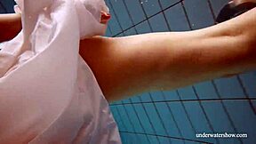 Lola shows her big natural tits while swimming underwater.