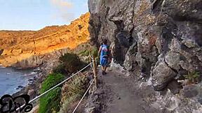 Teen gives blowjob on seaside cliff.