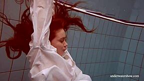 Lola shows her big natural tits while swimming underwater.