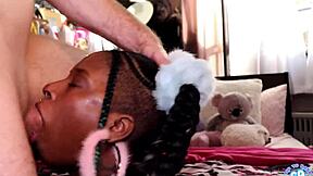 brunette with long hair in pigtails engages in intense oral activities at home.