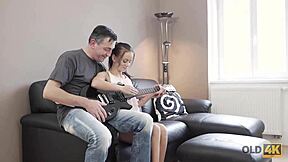 old guitarist lets young fan play instrument