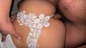 Little Asian girl in white thong enjoys playing with toys