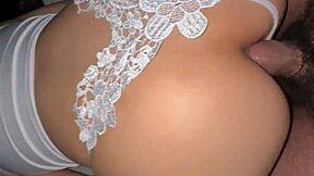 Little Asian girl in white thong enjoys playing with toys