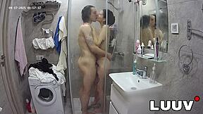 I join my boyfriend in the shower with webcam on, showing my shaved pussy.