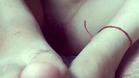 Petite babe gives footjob while masturbating.