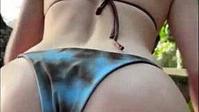 Horny teen in bikini gives oily titjob on public beach