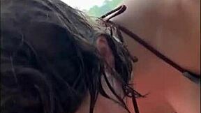 Horny teen in bikini gives oily titjob on public beach