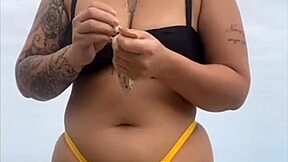 look at my swollen pussy in tight yellow bikini on beach
