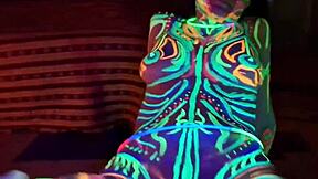 Wild slim brunette girl with long hair gets fucked doggystyle by big cock in UV light.