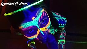 Wild slim brunette girl with long hair gets fucked doggystyle by big cock in UV light.