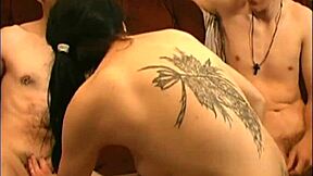 Samara Mae with pierced nipples and high heel boots gives handjob to two guys at once in homemade brunette scene.