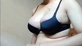 Young shemale strokes her big cock solo.