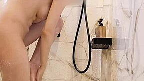 Bathing black-haired Japanese girl with ponytail and small tits